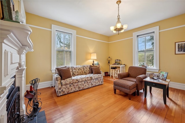 living room featuring a chandelier and wood-type flooring