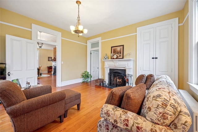 living room with a notable chandelier and light hardwood / wood-style flooring