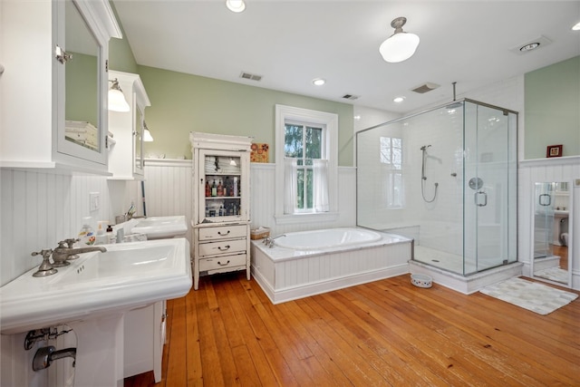 bathroom with hardwood / wood-style flooring and plus walk in shower