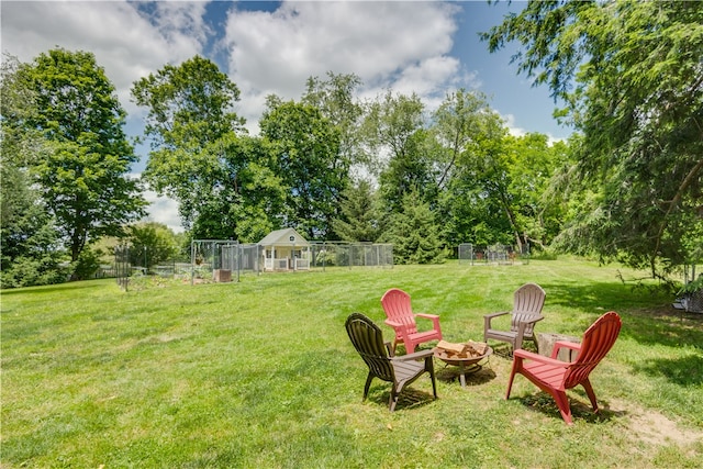 view of yard featuring an outdoor fire pit