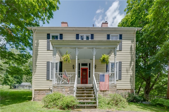 view of front of house with a front lawn and a porch