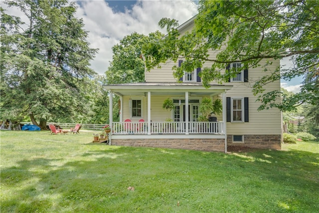 view of front of home featuring a front yard and covered porch