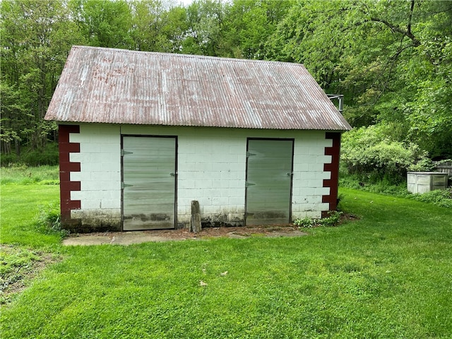 view of outbuilding featuring a lawn