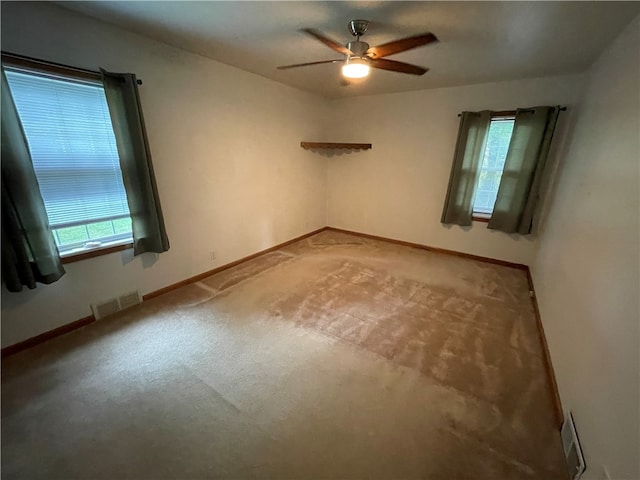 empty room featuring carpet floors and ceiling fan