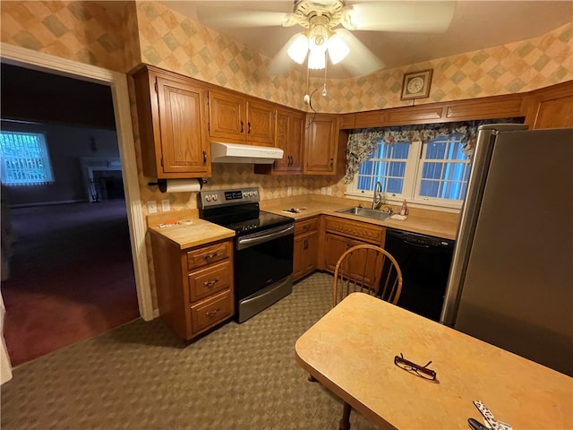 kitchen featuring sink, stainless steel appliances, light colored carpet, and ceiling fan