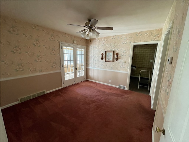 spare room featuring french doors, carpet flooring, and ceiling fan