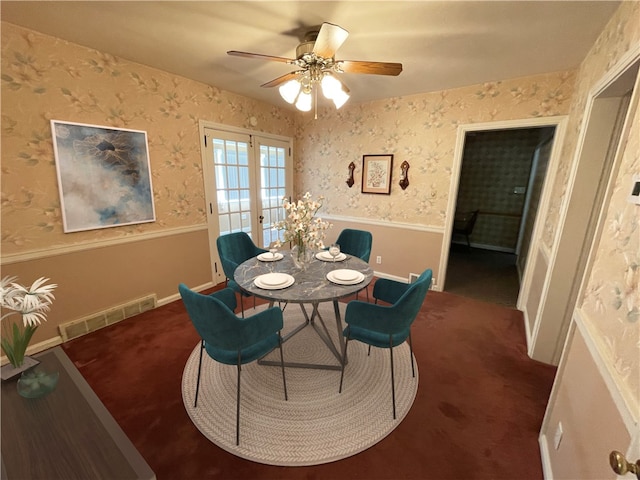 dining room featuring french doors, ceiling fan, and dark colored carpet