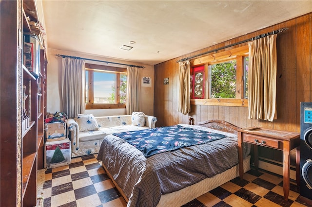 bedroom with a baseboard radiator and wooden walls