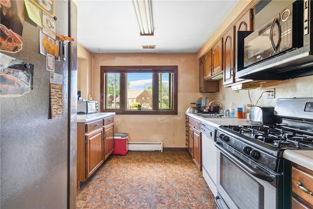 kitchen featuring gas stove, light tile floors, sink, dishwasher, and baseboard heating