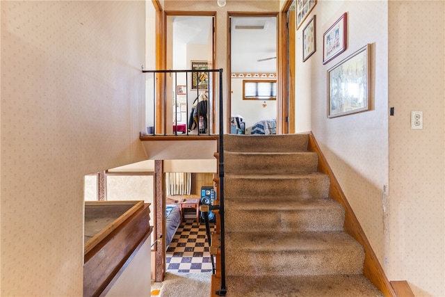 stairs with tile floors and ceiling fan