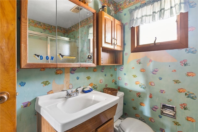 bathroom with toilet and large vanity