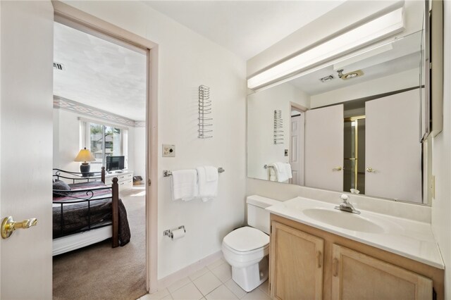 bathroom with vanity, toilet, and tile flooring