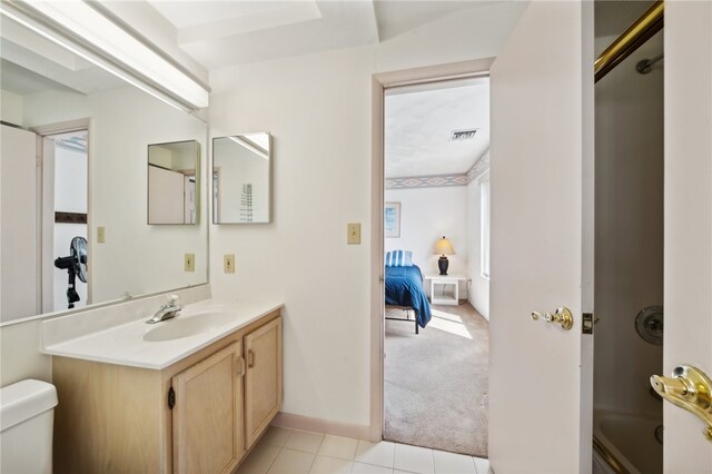 bathroom featuring vanity, toilet, and tile flooring