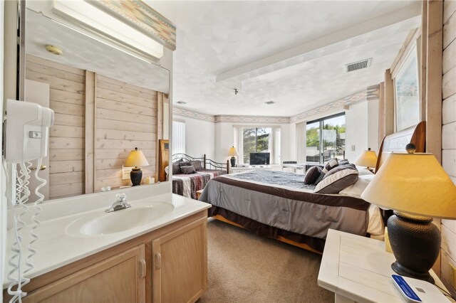 carpeted bedroom featuring sink