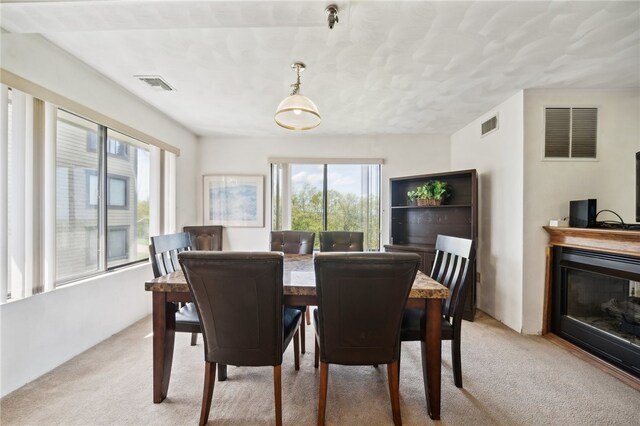 dining area featuring light carpet