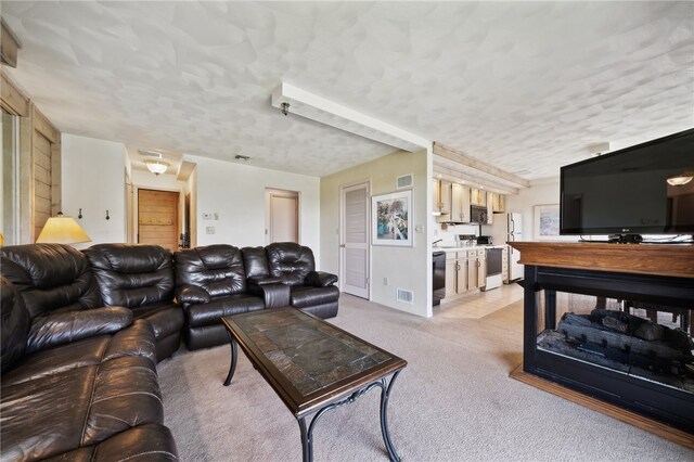 carpeted living room with a textured ceiling