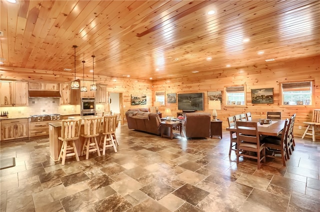 dining room featuring tile flooring and wood ceiling