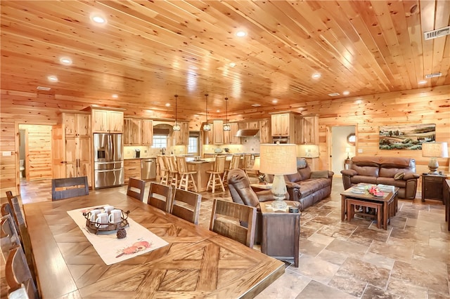 living room featuring wood ceiling, light tile floors, and wooden walls