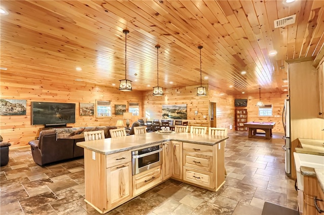 kitchen with wood walls, decorative light fixtures, stainless steel appliances, tile flooring, and wood ceiling