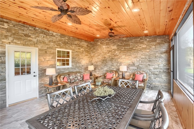 dining area featuring ceiling fan and wood ceiling