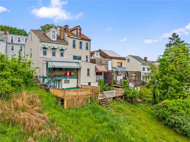 rear view of property featuring a wooden deck