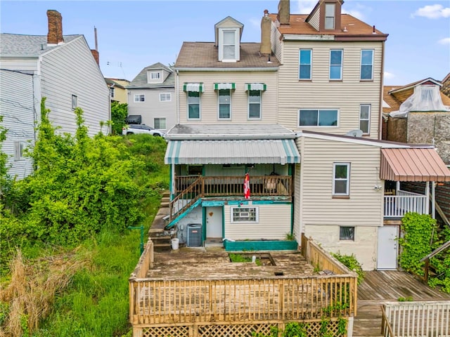 back of house with central AC unit and a wooden deck