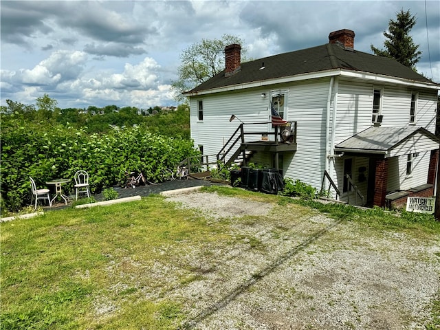 back of property featuring a yard