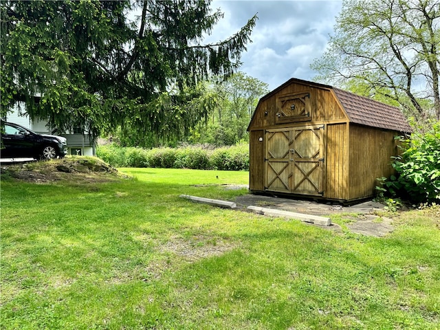 view of outbuilding featuring a yard