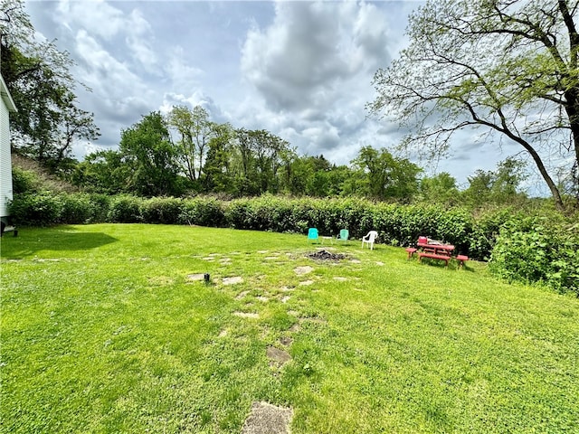 view of yard with an outdoor fire pit