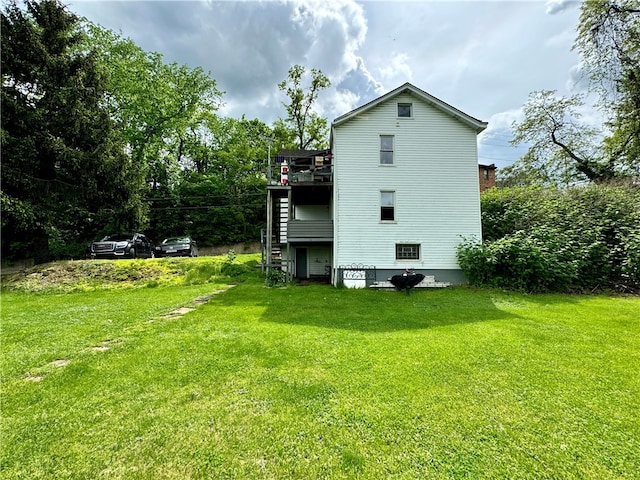 rear view of house featuring a yard