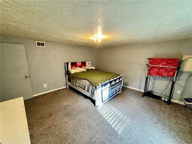 carpeted bedroom featuring a textured ceiling