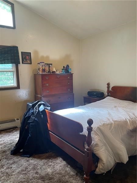 carpeted bedroom featuring lofted ceiling