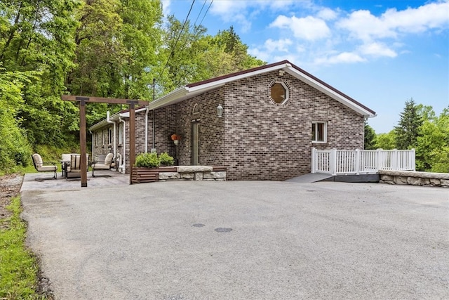 view of side of property with a patio area