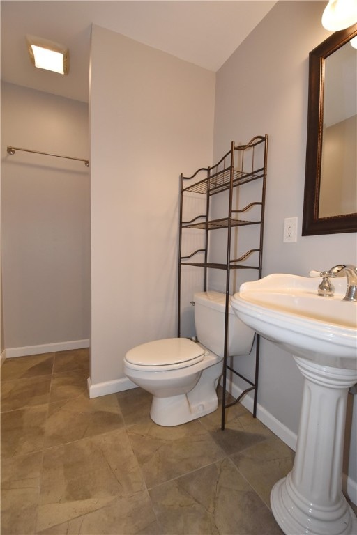 bathroom with toilet and tile flooring