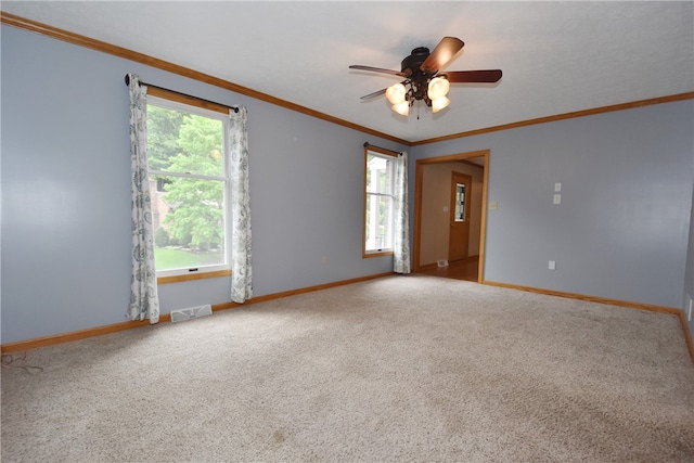 spare room with carpet, ceiling fan, and a healthy amount of sunlight