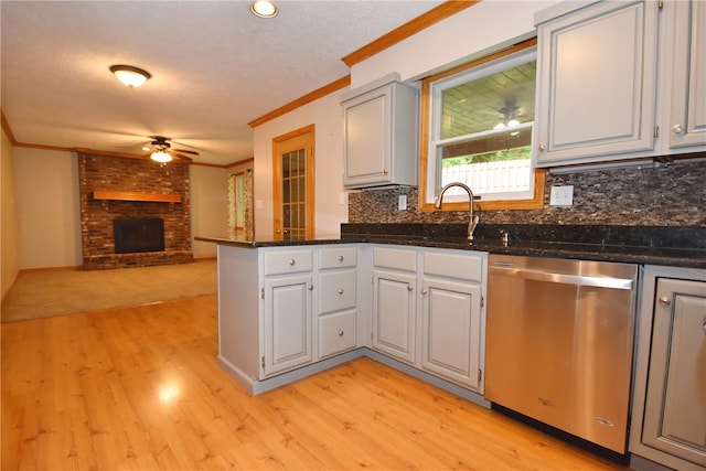 kitchen with tasteful backsplash, ceiling fan, light hardwood / wood-style floors, and stainless steel dishwasher