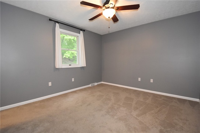 carpeted empty room featuring ceiling fan