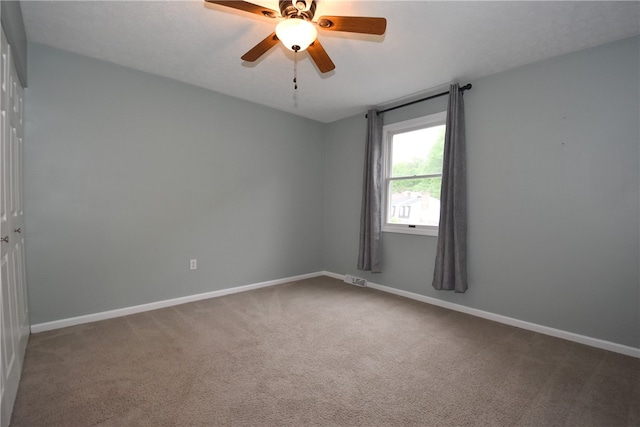 spare room with ceiling fan and carpet floors