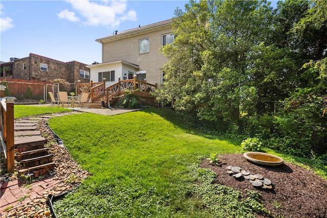 view of yard with a patio area and a wooden deck