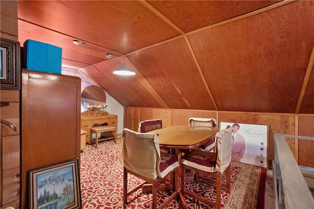 dining area with wooden walls, wooden ceiling, and lofted ceiling