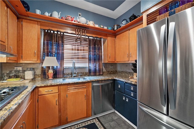 kitchen with backsplash, sink, stainless steel appliances, and tile floors