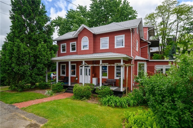 view of front of house with a front yard and covered porch