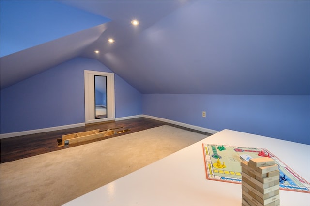 interior space featuring vaulted ceiling and dark hardwood / wood-style flooring