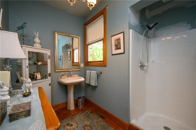 bathroom featuring walk in shower and parquet floors