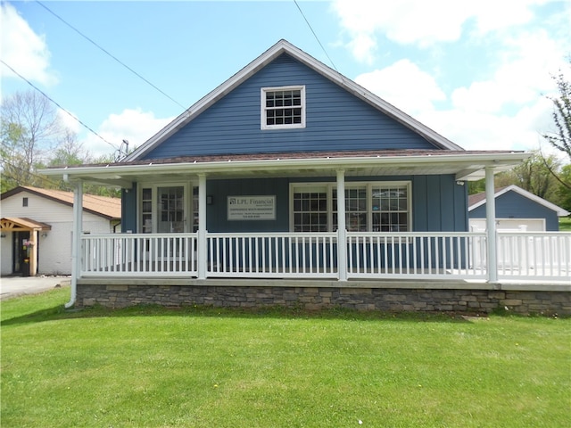 view of front of house with a front lawn, a garage, and covered porch