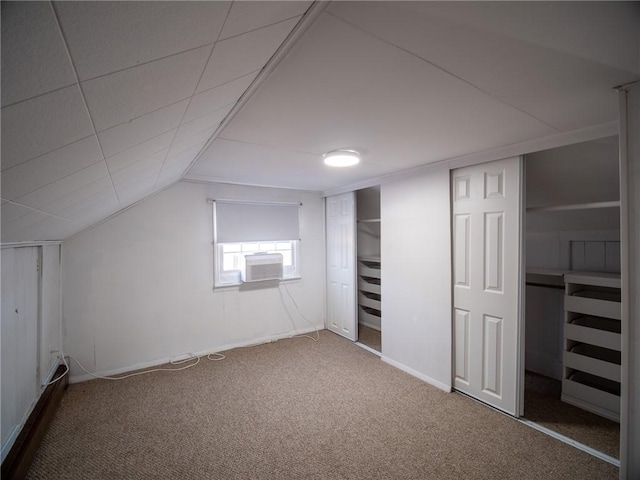 additional living space with lofted ceiling, carpet floors, and cooling unit