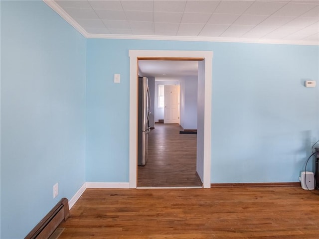 corridor featuring crown molding, a baseboard radiator, and dark wood-type flooring