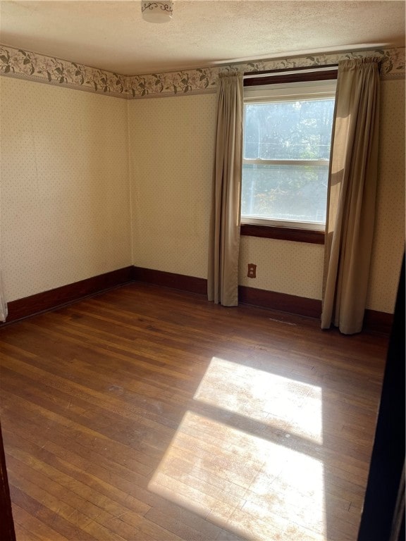 unfurnished room featuring hardwood / wood-style floors