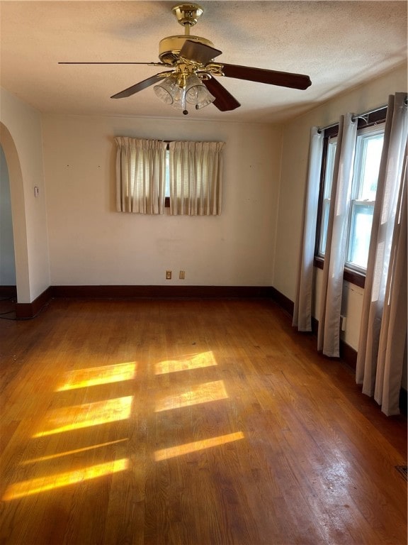 unfurnished room featuring ceiling fan and hardwood / wood-style floors