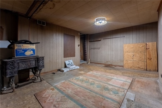 basement featuring wood walls